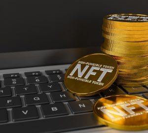 Moedas nft empilhadas em cima de um teclado de laptop